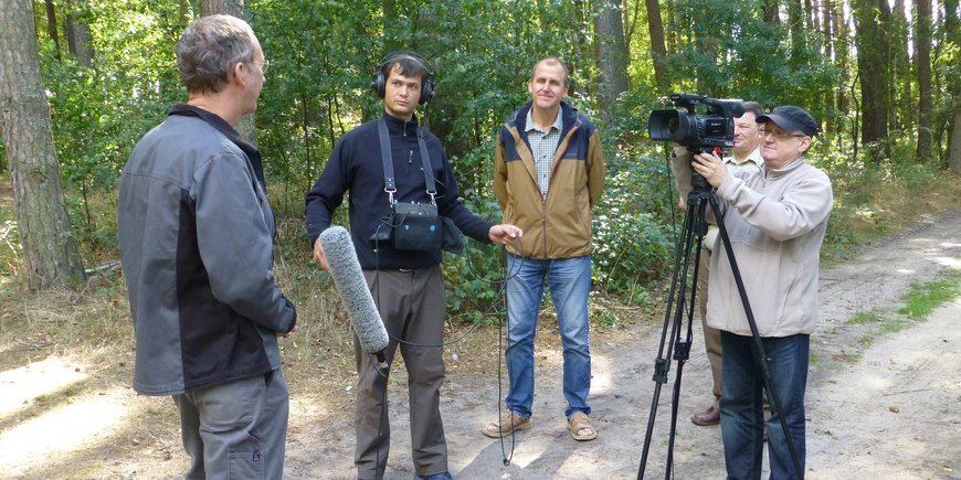 A camera team interviews Achim Brauer.