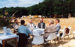 Egon Althaus sitting around a table with colleagues outside on a project